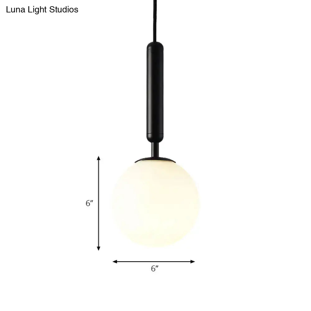 Decorbites modernist cylindrical pendant light with white glass globe and black gold finish available in adjustable inches fixture