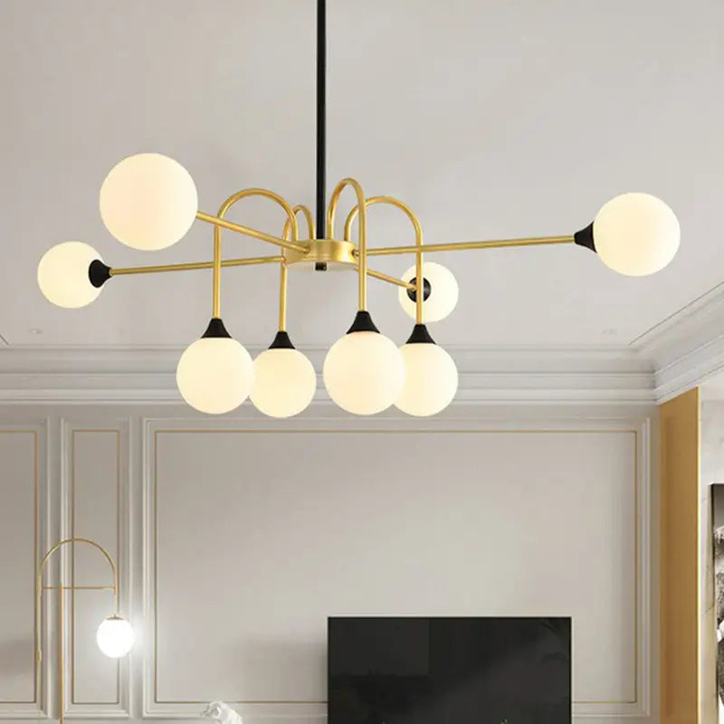 Gold-toned DecorBites Modo glass suspension light with six frosted globes and black accents for dining room use