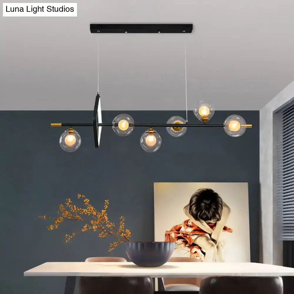 Modern black metal chandelier with five clear glass globe bulbs and gold accents for molecular dining room island pendant