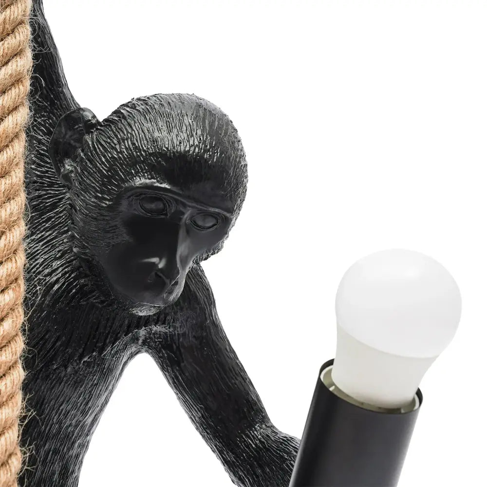 DecorBites™ monkey rope chandelier pendant light with black textured monkey decoration holding white bulb and hemp rope detail