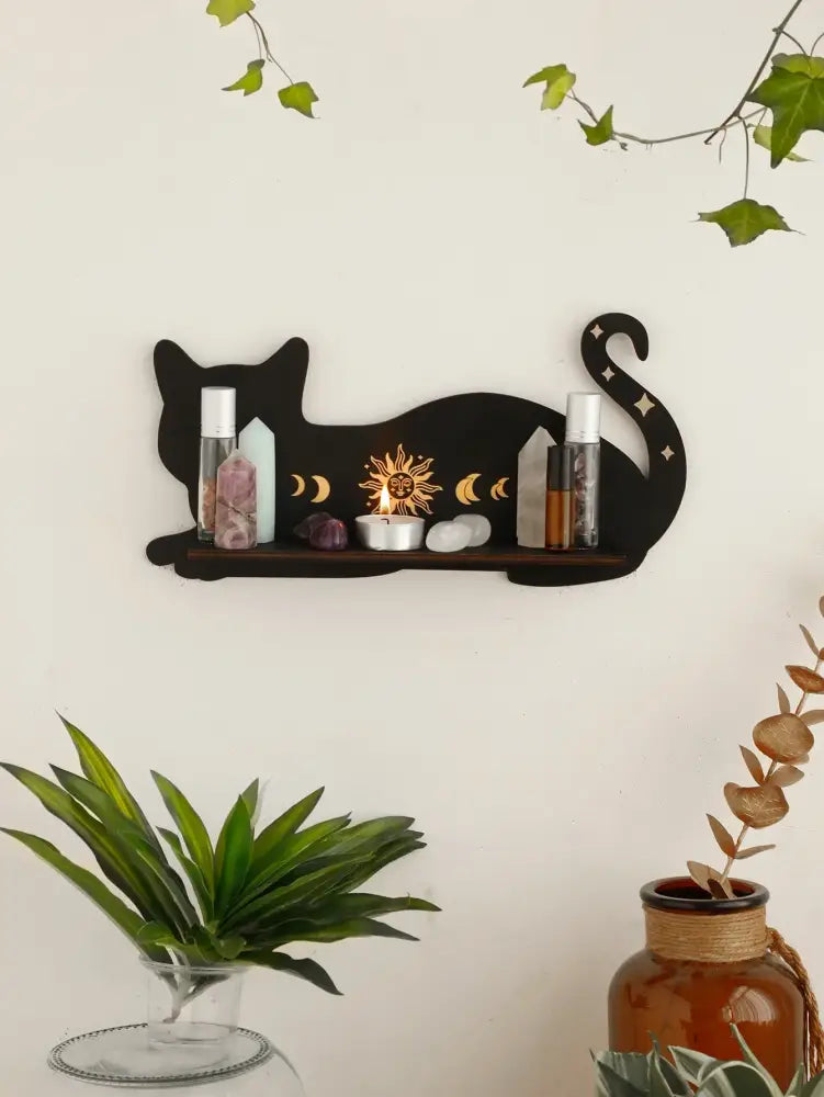 DecorBites™ moon phase black cat wooden shelf with sun and moon cutouts holding crystals and small bottles
