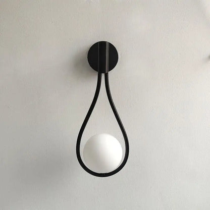 Black metal wall lamp with teardrop frame and white spherical bulb from DecorBites modern nordic wall lamp collection