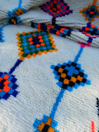 Plush white moroccan handmade azilal rug with vibrant blue orange green and black geometric patterns 2.5m x 1.5m
