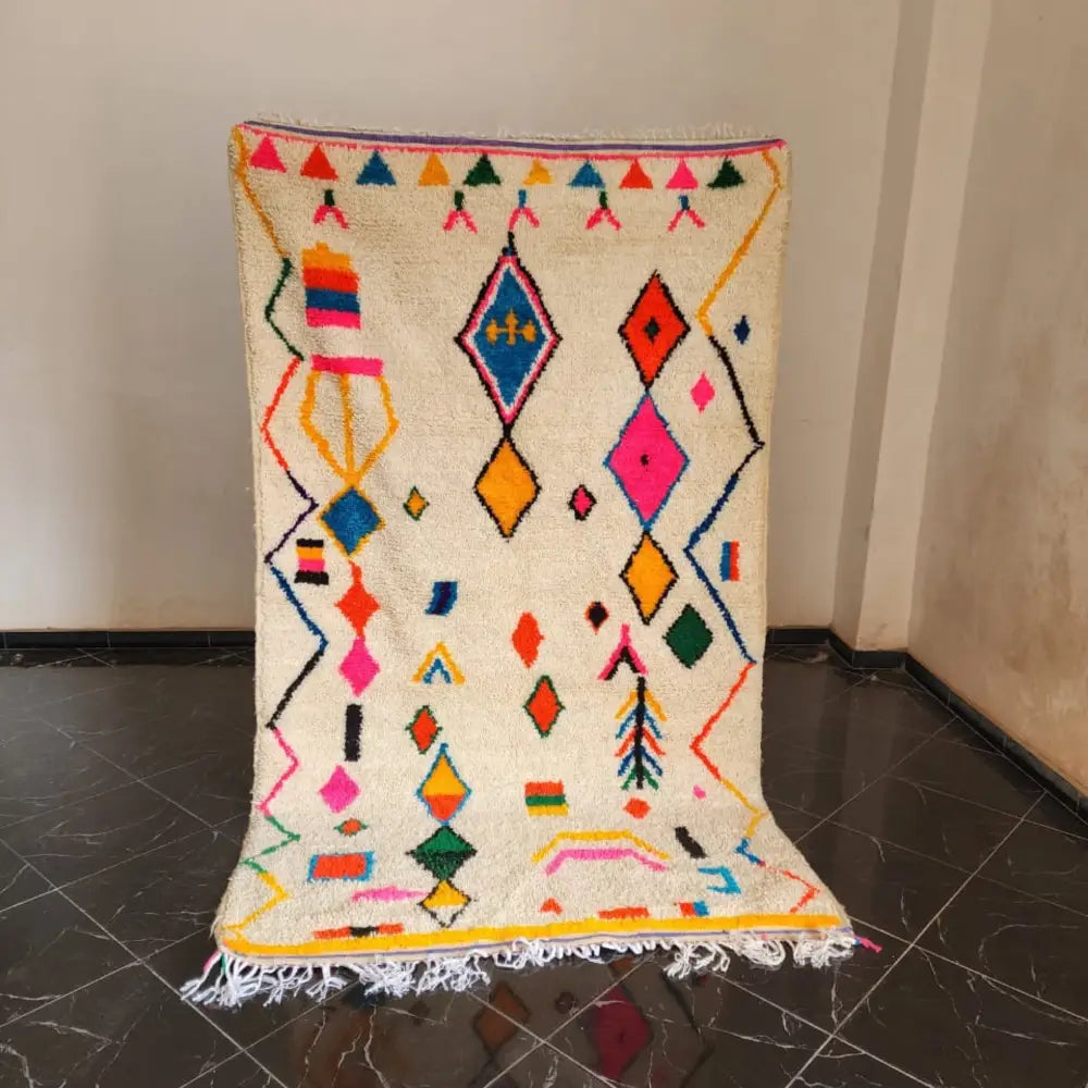 Vibrant cream moroccan handmade azilal rug with colorful diamond triangle motifs and fringed edges 2.5m x 1.5m