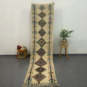 Cream-colored DecorBites™ moroccan handmade azilal rug 3m x 0.7m with intricate geometric patterns and fringed edges