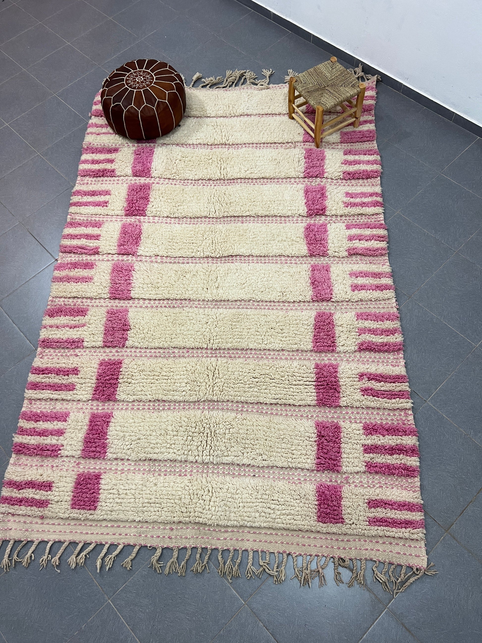 A plush cream and pink striped moroccan handmade azilal rug made of natural wool with fringed edges 3m x 2m