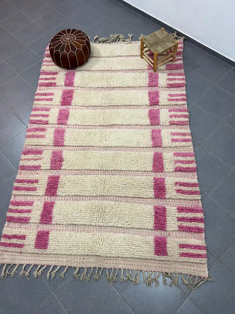 A plush cream and pink striped moroccan handmade azilal rug made of natural wool with fringed edges 3m x 2m