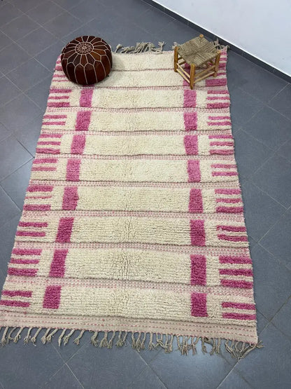 A plush cream and pink striped moroccan handmade azilal rug made of natural wool with fringed edges 3m x 2m