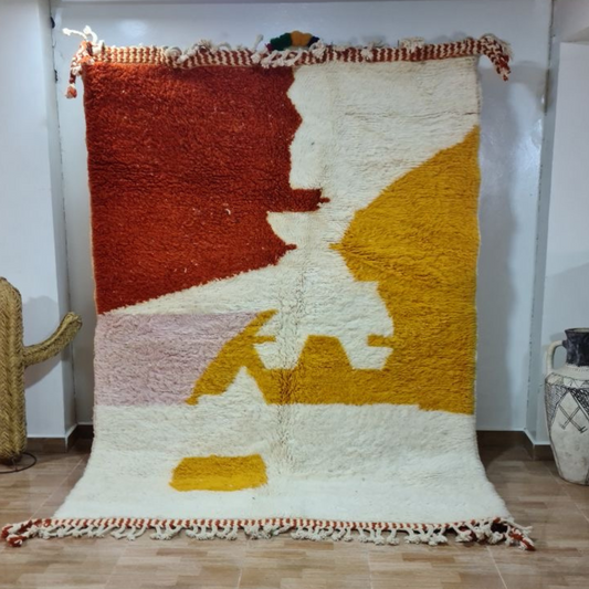 Vibrant chunky-knitted moroccan handmade beni ouarain rug with bold geometric patterns in rust cream mustard and blush pink