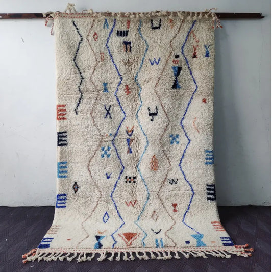Beige moroccan handmade beni ouarain rug with blue black and orange geometric patterns and fringed edges 2.5m x 1.5m