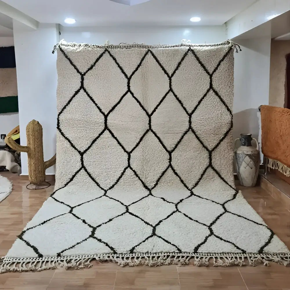 Cream-colored moroccan handmade beni ouarain rug 3m x 2m with bold black diamond lattice pattern and fringed edges