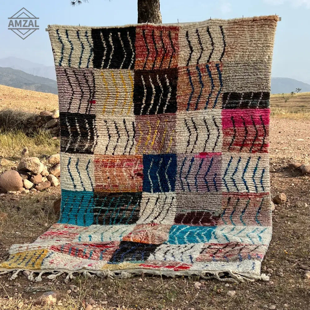 Colorful moroccan handmade boujaad rug with geometric patchwork in earthy and vibrant hues for decor or use