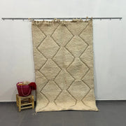 Beige moroccan handmade carpet with textured diamond pattern and fringed edges by skilled artisans for floor covering