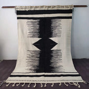 Black and cream-colored moroccan handmade hanbel rug with geometric patterns and tassels by decorbites made to order