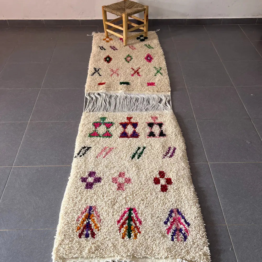 Cream-colored moroccan handmade beni ouarain rug with vibrant geometric patterns on a fluffy wool base 1.10m by 80cm