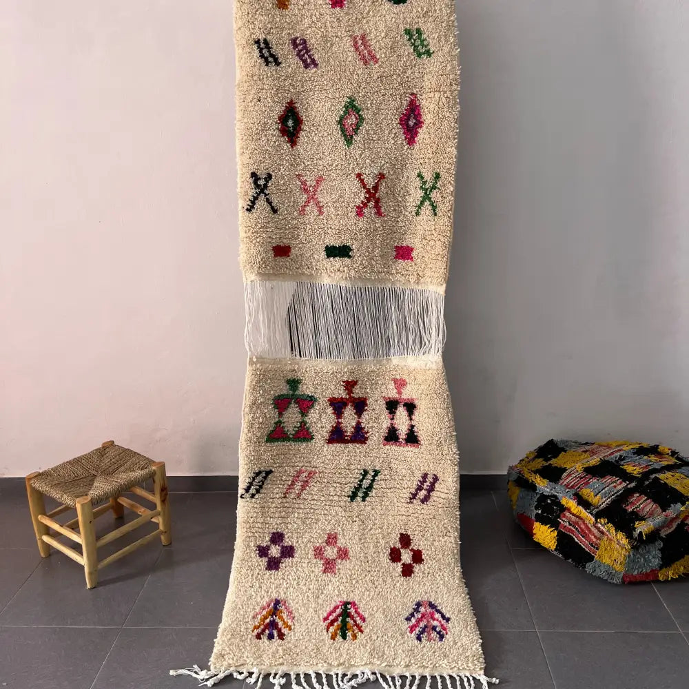 Beige moroccan handmade beni ouarain rug with colorful geometric patterns on textured woolen surface 1.10m 80cm