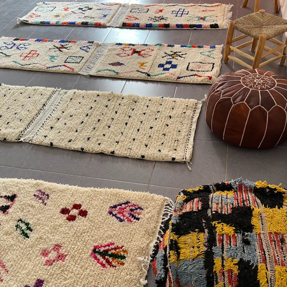 Cream-colored moroccan handmade beni ouarain rug with colorful geometric patterns and fringed edges 1m by 70cm