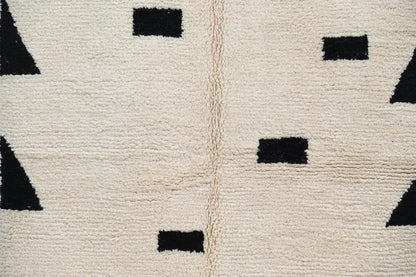 Cream-colored wool moroccan handmade traditional azilal rug with bold black geometric shapes 224 x 152 cm