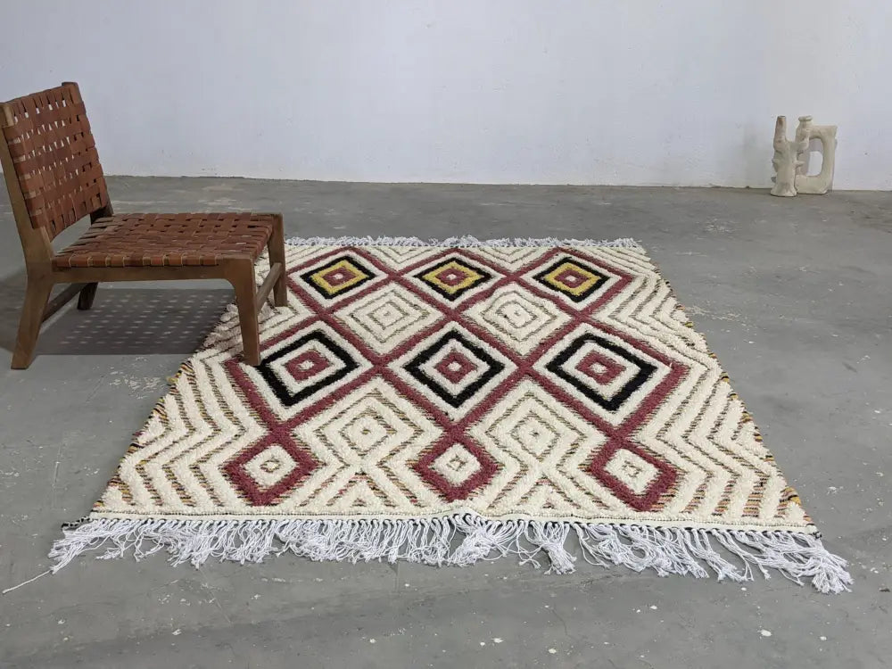 Cream-colored DecorBites™ moroccan handmade traditional azilal rug with geometric burgundy black mustard patterns and white fringe