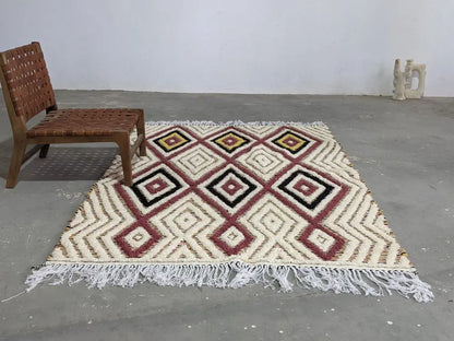 Cream-colored DecorBites™ moroccan handmade traditional azilal rug with geometric burgundy black mustard patterns and white fringe