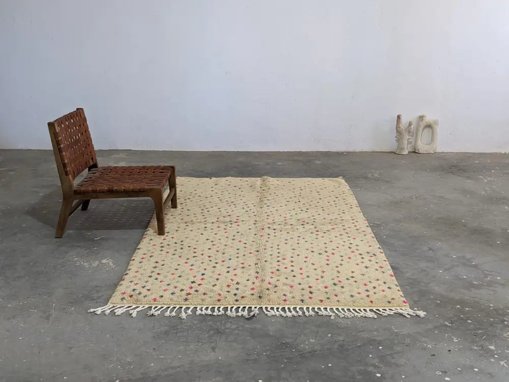 Beige moroccan handmade azilal rug with subtle red and green geometric patterns pure natural wool and white fringe