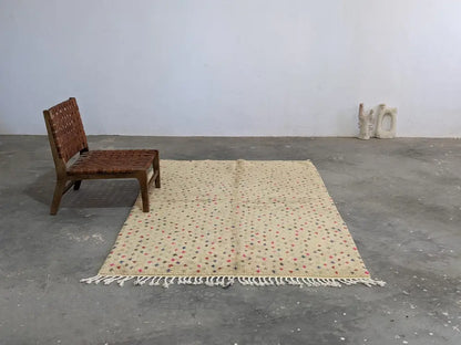 Beige moroccan handmade azilal rug with subtle red and green geometric patterns pure natural wool and white fringe