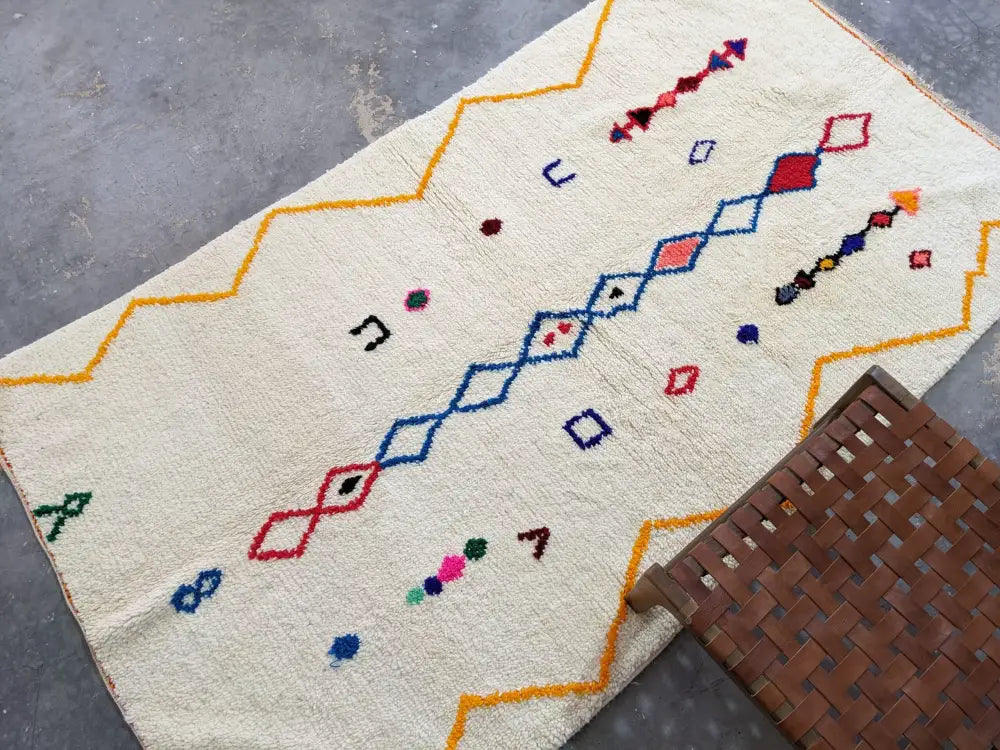 Cream-colored DecorBites™ moroccan handmade azilal rug with vibrant geometric patterns in pure natural wool