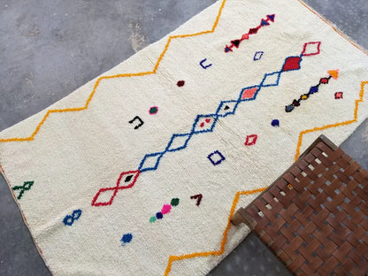 Cream-colored DecorBites™ moroccan handmade azilal rug with vibrant geometric patterns in pure natural wool