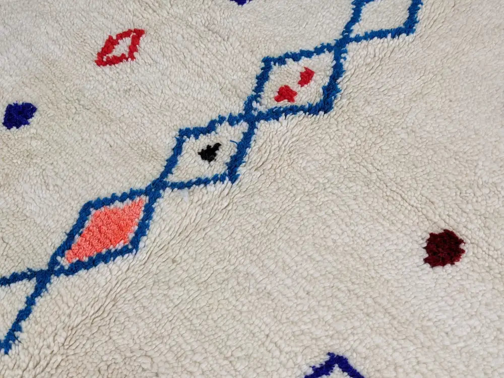 Cream-colored DecorBites™ moroccan handmade azilal rug with plush textured surface and bold geometric patterns in pure natural wool