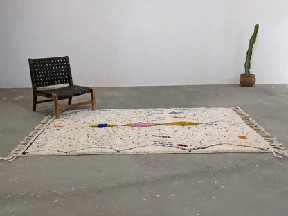 Cream-colored DecorBites™ moroccan handmade traditional azilal rug with textured geometric patterns in blue pink yellow and orange