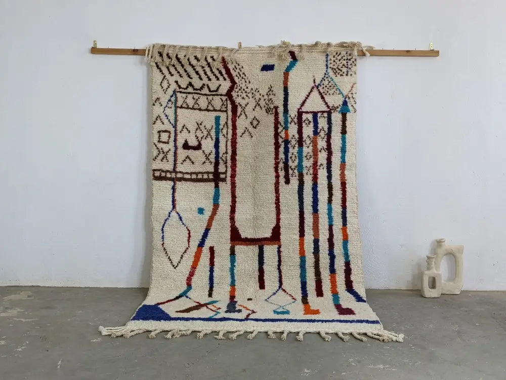 Beige moroccan handmade traditional azilal rug with geometric blue red and brown wool patterns 250 x 150 cm