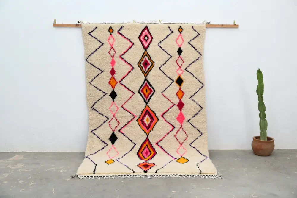 Beige moroccan handmade traditional azilal rug with vibrant pink orange and black geometric patterns 251 x 162 cm