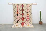 Beige moroccan handmade traditional azilal rug with vibrant pink orange and black geometric patterns 251 x 162 cm