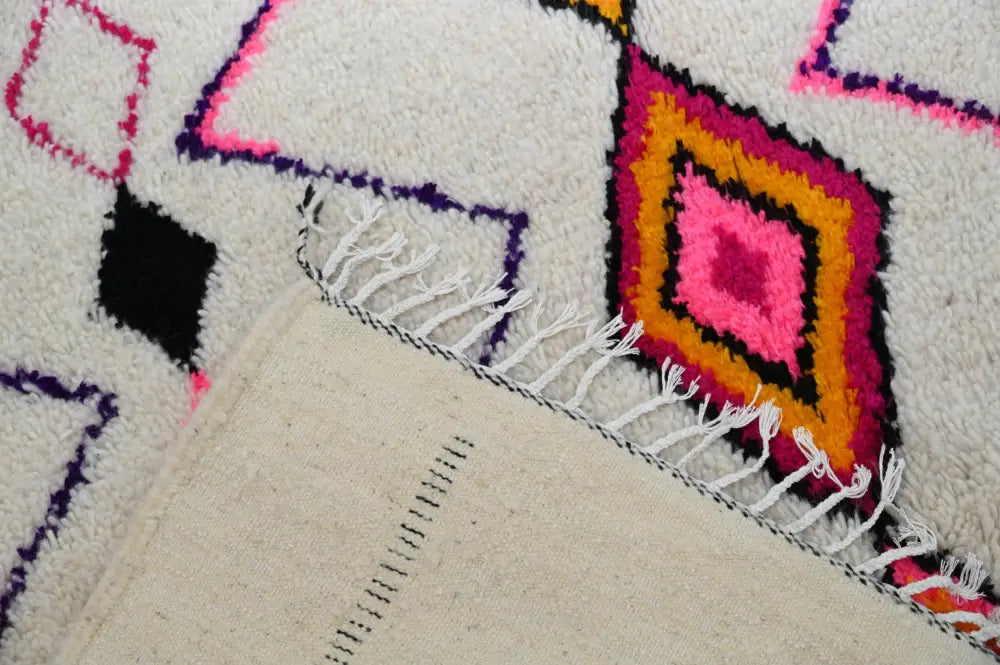 Decorbites moroccan handmade traditional azilal rug with cream base and bold pink orange purple black geometric patterns