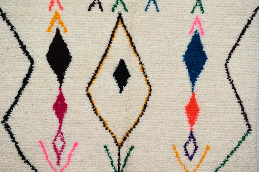 Cream-colored moroccan handmade traditional azilal rug with intricate geometric patterns in wool by DecorBites