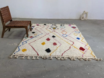 Cream-colored moroccan handmade traditional azilal rug with colorful geometric patterns and fringed woolen texture 252 x 160 cm