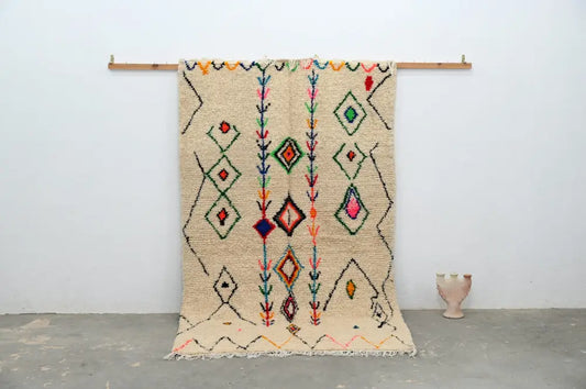 Beige moroccan handmade traditional azilal rug with colorful geometric patterns on textured woolen surface 253 x 154 cm
