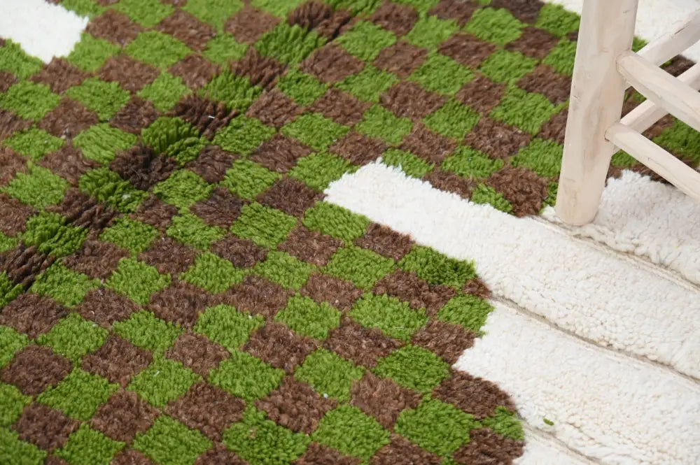 A plush, shaggy moroccan handmade traditional azilal rug with a vibrant green and earthy brown checkerboard pattern