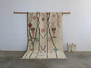 Beige moroccan handmade azilal rug with black red and blue geometric patterns in pure natural wool 253 x 165 cm