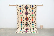 Beige moroccan handmade traditional azilal rug with colorful geometric patterns and fringed edges 255 x 144 cm