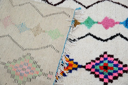 DecorBites™ moroccan handmade traditional azilal rug with cream base and vibrant pink green blue black geometric patterns