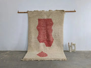 Beige woven moroccan handmade traditional azilal rug with bold red abstract leaf design and fringed edges 255 x 155 cm