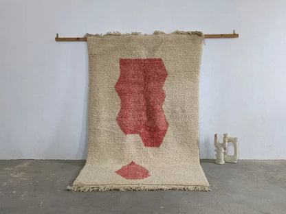 Beige woven moroccan handmade traditional azilal rug with bold red abstract leaf design and fringed edges 255 x 155 cm