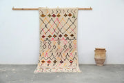 Beige moroccan handmade traditional azilal rug with geometric black pink orange and brown patterns 258 x 120 cm