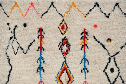 Cream-colored moroccan handmade traditional azilal rug with bold black orange red and blue geometric patterns 260 x 145 cm