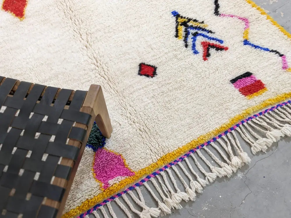 Cream-colored decorbites™ moroccan handmade traditional azilal rug with colorful geometric patterns and fringed edge 260 x 148 cm