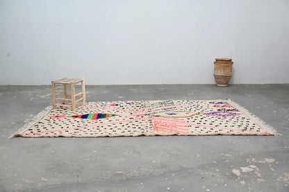 Beige moroccan handmade traditional azilal rug with black polka dots and colorful geometric patterns by DecorBites