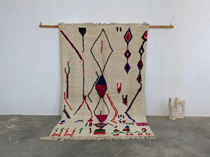 Beige moroccan handmade azilal rug with bold red blue and purple geometric patterns in pure natural wool 265x161 cm