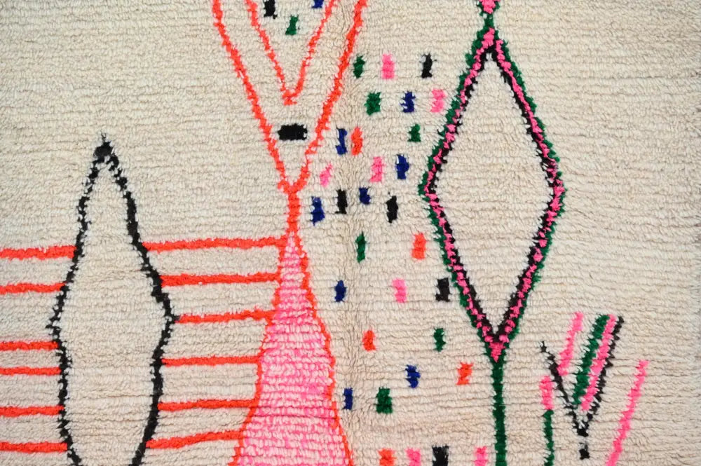 DecorBites™ moroccan handmade traditional azilal rug with bold geometric patterns in pink red green black on off-white