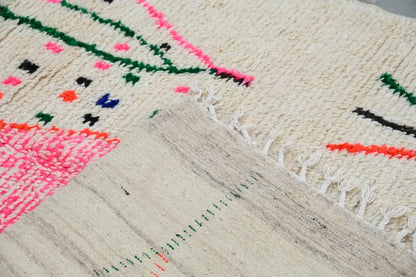 Beige moroccan handmade traditional azilal rug with vibrant pink green and orange geometric woolen patterns 268 x 157 cm